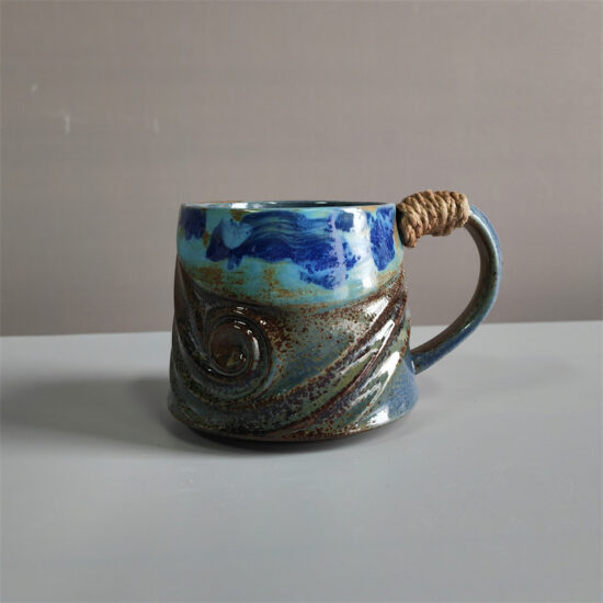 Unique irregular ceramic coffee mug with kiln-glazed surface