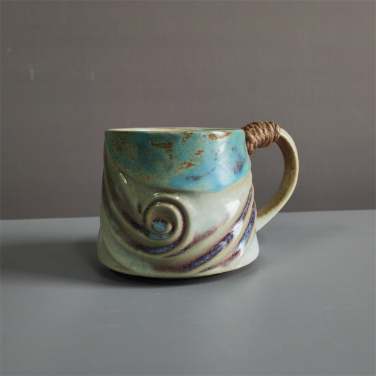 Unique irregular ceramic coffee mug with kiln-glazed surface
