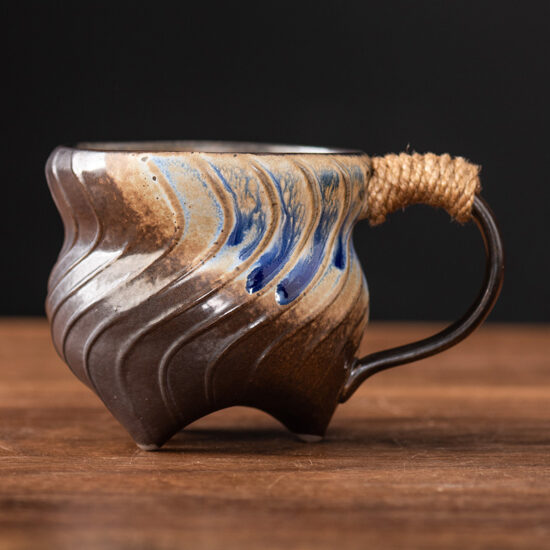 Unique irregular ceramic coffee mug with kiln-glazed surface