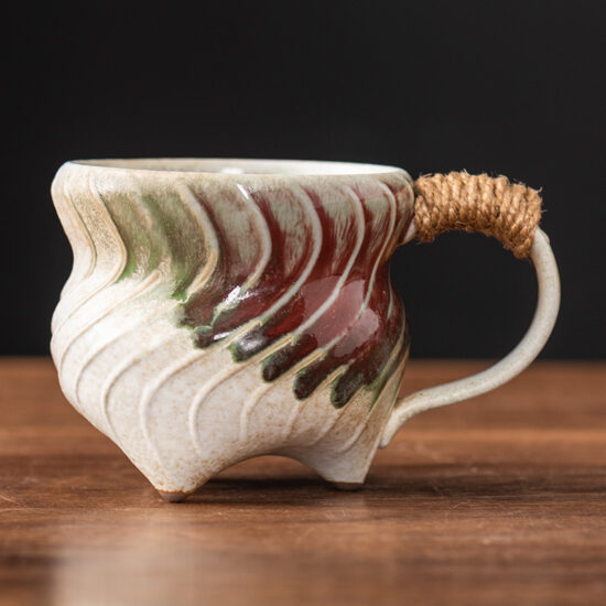 Unique irregular ceramic coffee mug with kiln-glazed surface