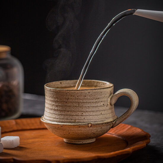 Handmade rustic ceramic milk cup with spoon, irregular shape coffee mug