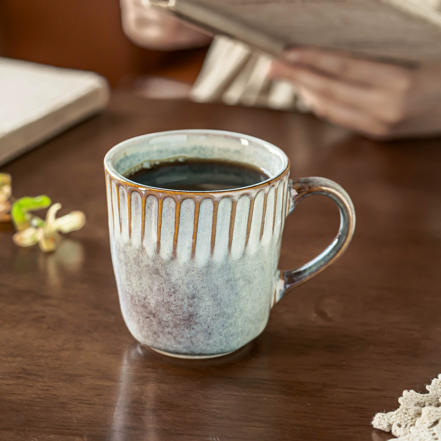 Reactive glaze ceramic coffee mug on wooden table