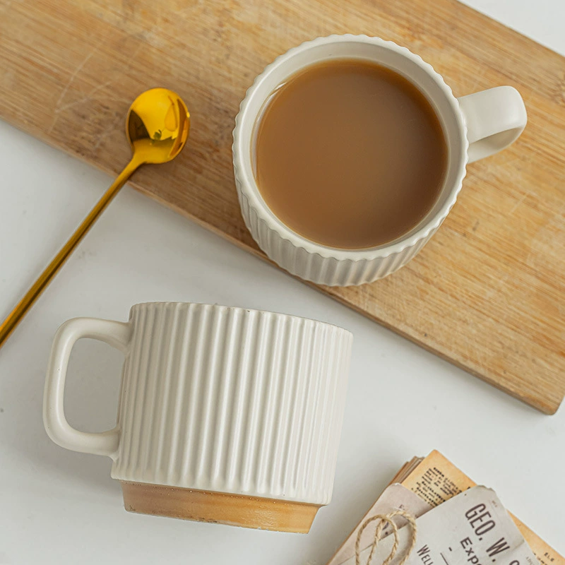 Top view of ribbed ceramic mugs with coffee and spoon