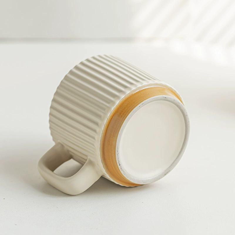 Ribbed ceramic mug shown from the bottom with wood color base