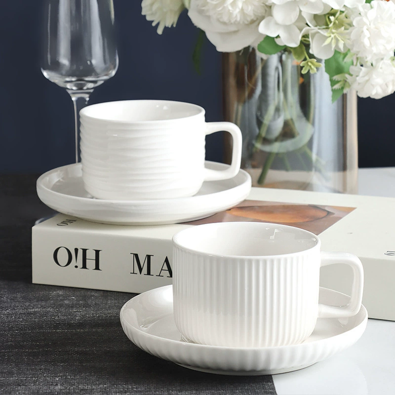 White ceramic cup and saucer set with ribbed and smooth cup styles
